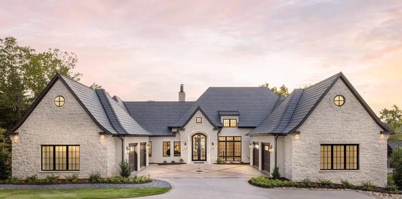 La Demeure Tranquille, a light-colored residence with steep gables and an arched front entry