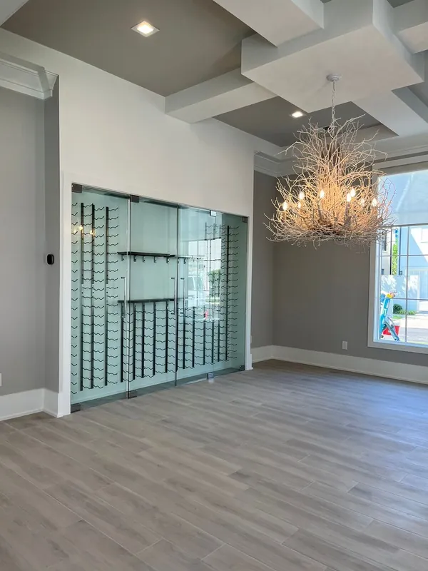 Finished room with light painted walls, white trim and a detailed ceiling