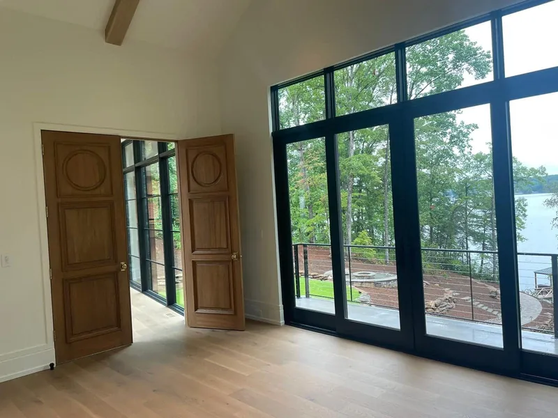 Bright room with cream walls, wood flooring and black-framed windows